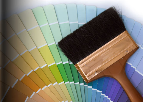 Cans of paint, brushes, rollers, and painting accessories for home renovation and DIY projects.