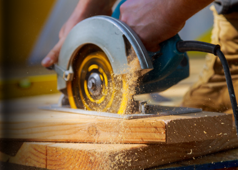 Electric drills, saws, sanders, and power tool accessories arranged in a hardware store display."